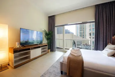 a bedroom with a large bed and a large window at HiGuests - Chic Studio in Downtown Dubai in Dubai
