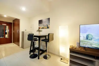 a living room with a table and a flat screen tv at HiGuests - Chic Studio in Downtown Dubai in Dubai