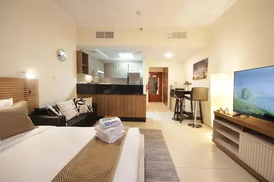 a living room with a couch and a flat screen tv at HiGuests - Chic Studio in Downtown Dubai in Dubai