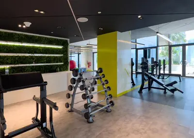 a gym with treadmills and elliptical machines at Aykon Tower - Studio Apartment - Allsopp & Allsopp in Dubai