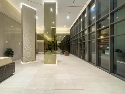 an empty hallway of an office building with glass doors at Downtown 1BR Pool with Burj Khalifa View Near Dubai Mall in Dubai