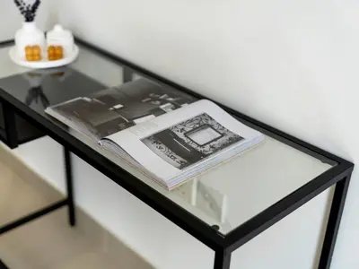 a glass table with a book on top of it at Downtown 1BR Pool with Burj Khalifa View Near Dubai Mall in Dubai