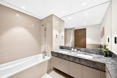 a bathroom with a tub and a sink and a bath tub at 28th Floor Apartment Next to Burj And Mall Sleeps 7 in Dubai