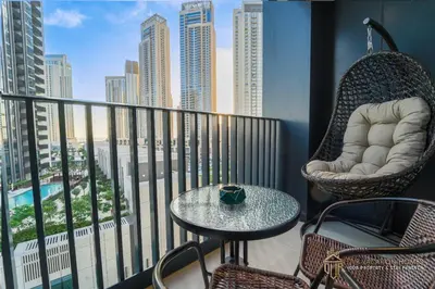 a balcony with a table and chairs and a view of the city at Modern 1BR Apartment in Dubai Creek Harbour by DVR Vacation Homes in Dubai
