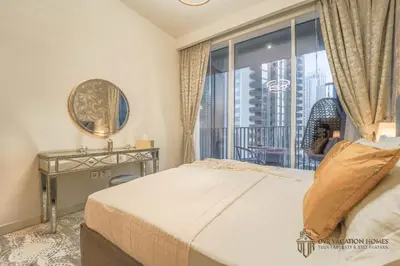 a bedroom with a bed and a large window at Modern 1BR Apartment in Dubai Creek Harbour by DVR Vacation Homes in Dubai
