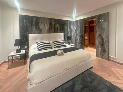 a bedroom with a large bed with a teddy bear on it at Luxury 3BR Villa with Pool View & Modern Comfort in Dubai