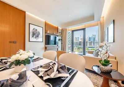 a dining room with a table and chairs with a view at Luxury 2BR at Address Opera with Burj Khalifa View in Dubai