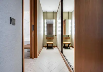 a hallway with two chairs and a mirror in a room at Luxury 2BR at Address Opera with Burj Khalifa View in Dubai