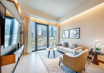 a living room with a couch and a tv at Luxury 2BR at Address Opera with Burj Khalifa View in Dubai