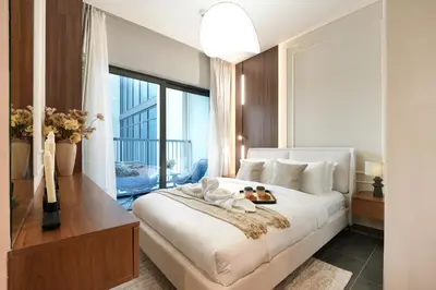 a bedroom with a large bed with two dolls on it at Trophy - Modern 2BR in Crest Tower in Dubai