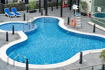 a swimming pool with a slide in a building at Escape24 Spacious 1BR with Pool View, JVC in Dubai