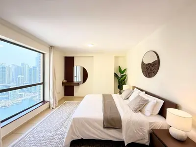 a bedroom with a bed and a large window at Tiramisu - Luxurious 2 BR Apartment- JBR Beach in Dubai