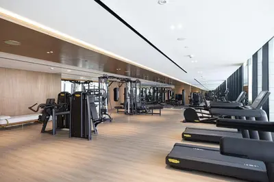 a gym with treadmills and machines in a room at Trillionaire Studio, Canal Views, Private Jacuzzi in Dubai