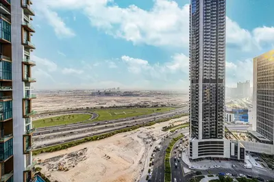 an aerial view of a city with a tall building at Paramount Luxe Suite, Business Bay in Dubai