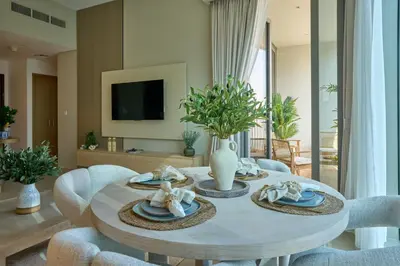 a dining room with a table and chairs at Coastal 1BR with Balcony and Marina Ain Dubai Bluewaters Views in Dubai