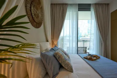 a bedroom with a bed and a large window at Coastal 1BR with Balcony and Marina Ain Dubai Bluewaters Views in Dubai