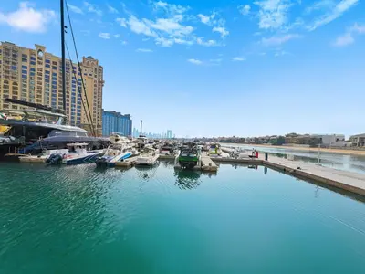 a group of boats are docked in a marina at Amazing Views of Palm & Dubai Eye Stylish Studio in Dubai