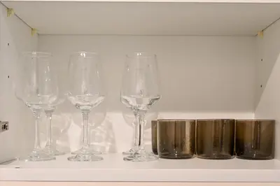 a row of wine glasses sitting on a shelf at Amazing Views of Palm & Dubai Eye Stylish Studio in Dubai