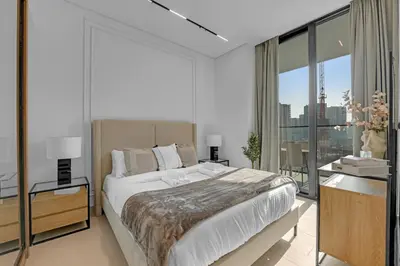 a bedroom with a large bed and a large window at Modern Luxe | Heart of Dubai | Trillionaire Living in Dubai