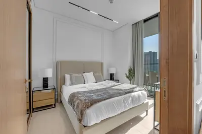 a bedroom with a large bed and a large window at Modern Luxe | Heart of Dubai | Trillionaire Living in Dubai