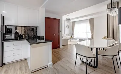 a kitchen and dining room with a table and chairs at Stylish 2-Bedroom Apartment with Marina View JBR in Dubai