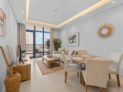 a living room with a table and a couch at Convenient City Apartment Near Metro & Downtown in Dubai