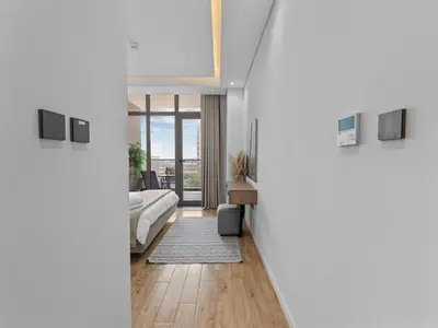 a bedroom with a bed and a large window at Convenient City Apartment Near Metro & Downtown in Dubai