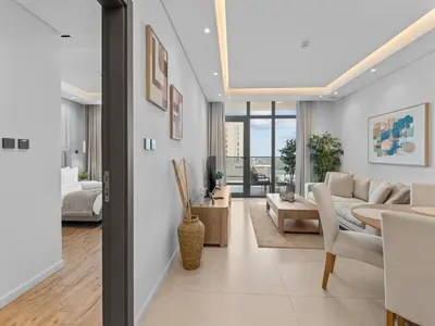 a living room with a couch and a table at Convenient City Apartment Near Metro & Downtown in Dubai