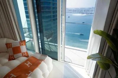 a room with a window with a view of the ocean at Palace Beachfront Dubai Harbour in Dubai
