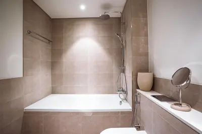 a bathroom with a tub and a toilet and a shower at Palace Beachfront Dubai Harbour in Dubai