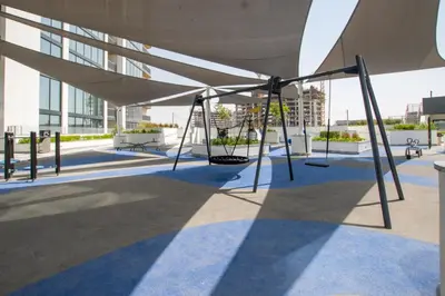 a swing set on the roof of a building at Modern Stay at The Crest Tower Near Meydan with Pool and Sauna in Dubai