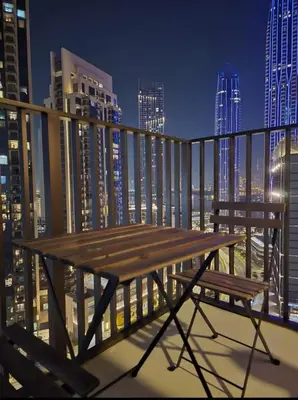 a wooden bench sitting on top of a balcony at Creek crescent in Dubai