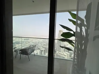 a balcony with a bench and a view of the city at Luxury two beds apartment in Dubai