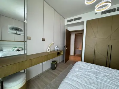 a bedroom with a bed and a sink and a mirror at Luxury two beds apartment in Dubai