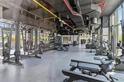 a gym with cardio equipment and treadmills at Deluxe Studio for 2 in Peninsula One, Business Bay in Dubai