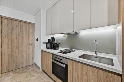 a kitchen with a sink and a stove at Deluxe Studio for 2 in Peninsula One, Business Bay in Dubai