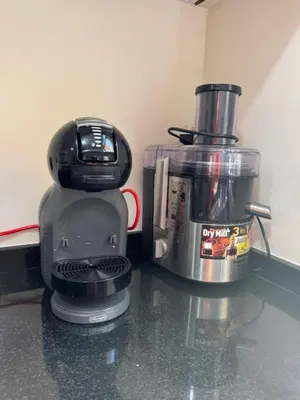 a coffee maker sitting on a counter next to a blender at Luxury Smart Home Villa Damac Hills 2 3BR Ensuite in Dubai