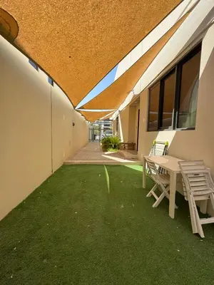 a patio with a table and chairs in a building at Luxury Smart Home Villa Damac Hills 2 3BR Ensuite in Dubai