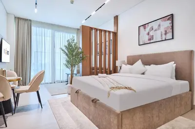 a bedroom with a large bed and a dining room at Glamorous Trillionaire Living in Dubai