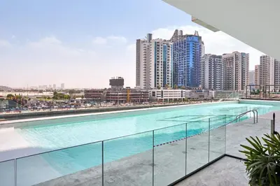 a large swimming pool in a city with tall buildings at Glamorous Trillionaire Living in Dubai