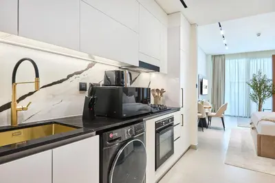 a kitchen with a sink and a dishwasher at Glamorous Trillionaire Living in Dubai