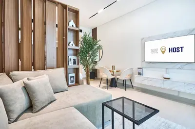 a living room with a couch and a tv at Glamorous Trillionaire Living in Dubai