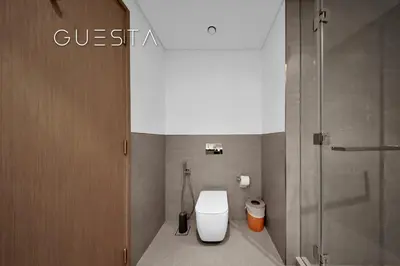 a bathroom with a toilet and a shower at Grande Tower by Emaar, Downtown, Burj Khalifa in Dubai
