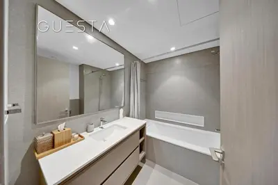 a bathroom with a sink and a mirror at Grande Tower by Emaar, Downtown, Burj Khalifa in Dubai