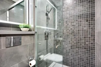 a bathroom with a shower with a glass door at STAY BY LATINEM Luxury 1BR Holiday Home CB 0607 Near Burj Khalifa in Dubai