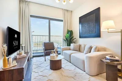 a living room with a couch and a table at STAY BY LATINEM Luxury 1BR Holiday Home CB 0607 Near Burj Khalifa in Dubai