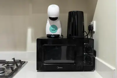 a coffee maker is sitting on top of a microwave at Dubai Luxury 2BR - Pool, Gym & Burj Khalifa View in Dubai