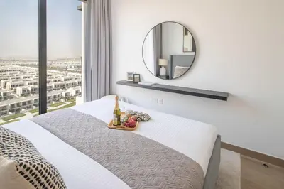 a bedroom with a white bed and a mirror at Frank Porter - Liva, Townsquare in Dubai