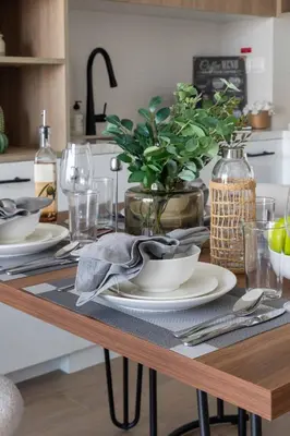 a table with plates and dishes on it in a kitchen at Frank Porter - Liva, Townsquare in Dubai
