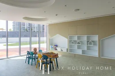a child sitting at a table in a room with windows at LUX The Burj Khalifa Lagoon View Suite 4 in Dubai